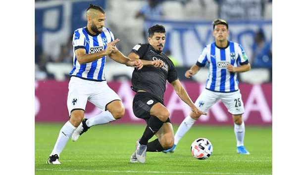 Al Saddu2019s Baghdad Bounedjah (centre) vies for the ball during the FIFA Club World Cup match against Monterrey at Jassim Bin Hamad Stadium in Doha yesterday. PICTURE: Noushad Thekkayil