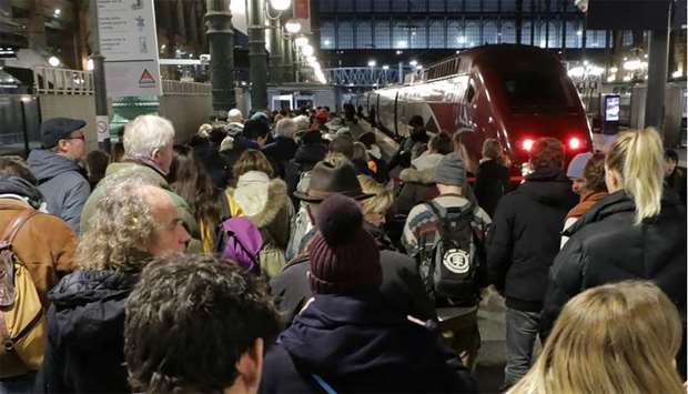 Commuters wait to take a train at Gare du Nord train station during a strike by all unions of French SNCF workers and the Paris transport network (RATP), as France faces its 11th consecutive day of strikes against French government's pensions reform plans, in Paris