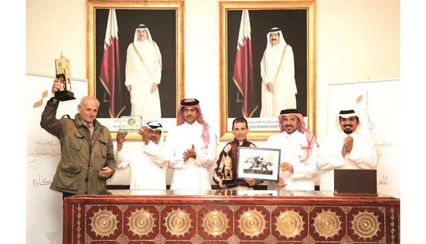 Qatar Equestrian Federation (QEF) and Asian Equestrian Federation President Hamad Abdulrahman al-Attiyah (third from left) and QREC CEO Nasser Sherida al-Kaabi (right) with the winners of The Late Sheikh Jassim Bin Mohammed Al Thani Trophy - Qatar National Day Trophy at Al Rayyan Park yesterday. PICTURES: Juhaim
