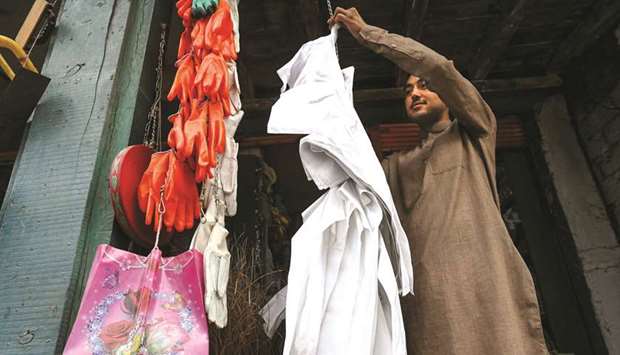 This picture taken earlier this year shows a shopkeeper arranging plastic bags for sale at a market.