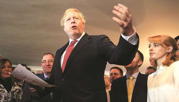 Johnson gestures while speaking with supporters on a visit to meet newly-elected Conservative party MP for Sedgefield, Paul Howell, at Sedgefield Cricket Club in County Durham, northeast England.