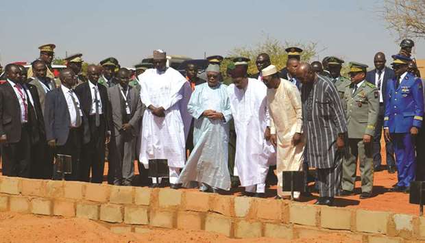 The leaders of various Sahel nations pray in front of the graves of the fallen soldiers in Niamey, yesterday.