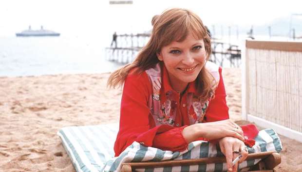 In this file photo taken in 1973, Karina poses at the beach during the Cannes Film Festival.