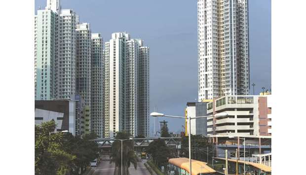 Residential buildings stand in the Tin Shui Wai district of Hong Kong. Strong pent-up demand, low interest rates and easier access to credit, and confident developers have supported the property market in Hong Kong.
