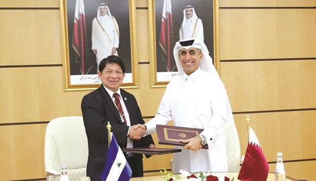 HE Dr Ibrahim bin Saleh al-Nuaimi and Denis Ronaldo Moncada Colindres exchange documents after signing the agreement.