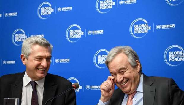United Nations High Commissioner for Refugees Filippo Grandi (L) and United Nations Secretary-General Antonio Guterres speak as they attend a press conference during the opening of the Global Refugee Forum in Geneva