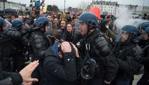 People take part in a demonstration in Nantes to protest against the French government's plan to overhaul the country's retirement system