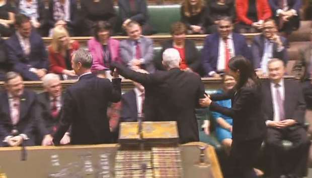 A still image taken from footage broadcast by the UK Parliamentary Recording Unit (PRU) shows Hoyle being ceremonially dragged from the benches to the Speakeru2019s Chair after being re-elected to the position.