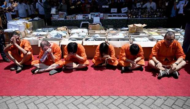Accused drug smugglers from Hong Kong, Singapore, Thailand, Chile and Switzerland attend a press conference at the customs office near Ngurah Rai Airport in Denpasar on Indonesia's resort island of Bali