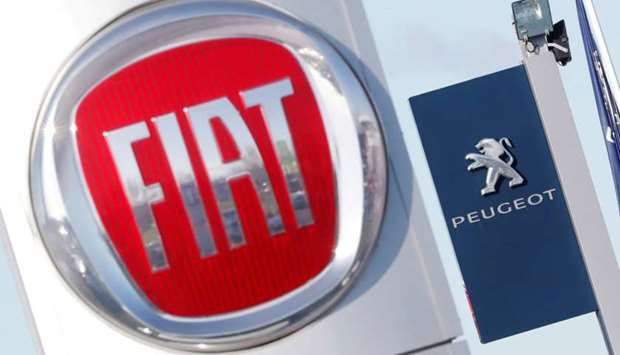The logos of car manufacturers Fiat and Peugeot are seen in front of dealerships of the companies in Saint-Nazaire, France, November 8, 2019