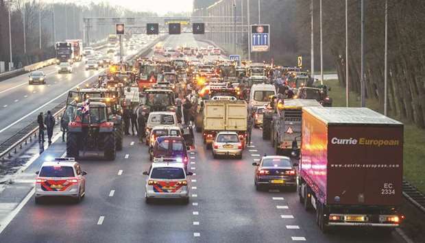 Dutch farmers use tractors to blockade the A9 Highway at Uitgeest, north of Amsterdam, to protest a clampdown on nitrogen emissions that they claim could wreak havoc on their businesses.