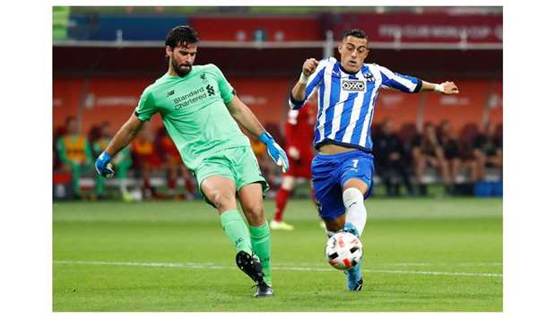 Liverpoolu2019s Alisson (left) in action with Monterreyu2019s Rogelio Funes  during the FIFA Club World Cup semi-final at Khalifa International Stadium in Doha on Wednesday. (Reuters)