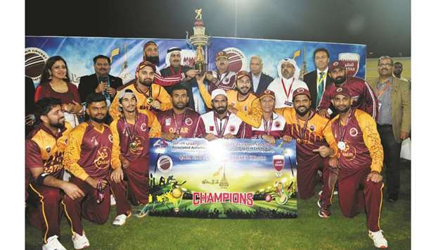 Qatar Stars Eleven players celebrate with the trophy after winning the cricket match organised by the QCA to mark the Qatar National Day.