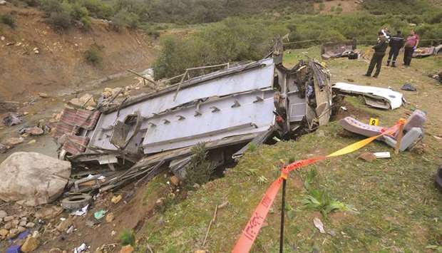 Security forces check the debris of a bus that plunged over a cliff into a ravine, in Ain Snoussi in northern Tunisia, yesterday.