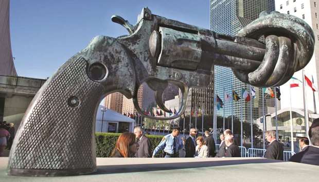 People walk past a sculpture outside the UN headquarters in New York.
