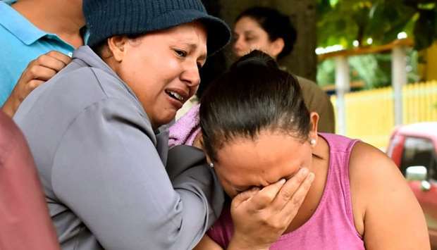 Relatives of inmates react after getting information about their loved ones in front of the penitentiary of Tela, Atlantida department, Honduras