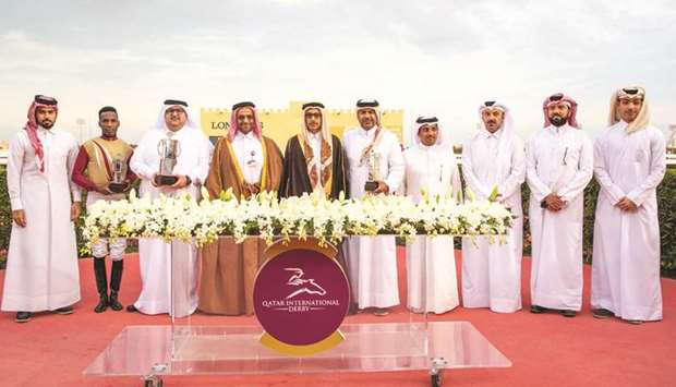 Minister of Culture and Sports HE Salah bin Ghanem bin Nasser al-Ali (fifth from left) with the winners of the Qatar Derby for three-year-old Local Thoroughbreds after Abdulatif Hussain al-Emadiu2019s Black Pearl won the 1,850m race yesterday. PICTURES: Juhaim and Zuzanna Lupa