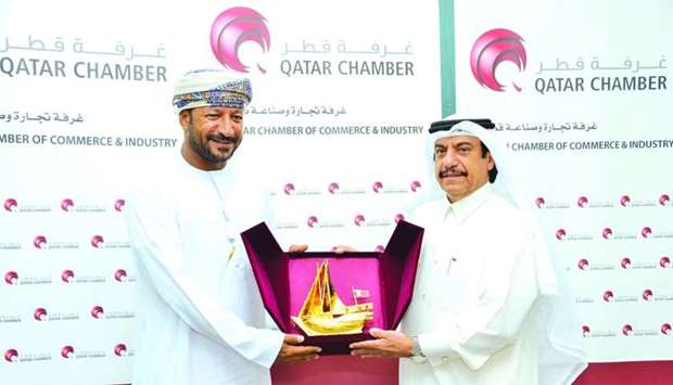 Qatar Chamber assistant director general for Government Relations and Committee Affairs Ali bu Sherbak al-Mansouri handing over a memento to Oman Chamber of Commerce and Industry chairman Ali bin Salim al-Hajari after a meeting held in Doha