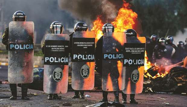 Demonstrators clash with riot police during a protest against the government in Santiago.