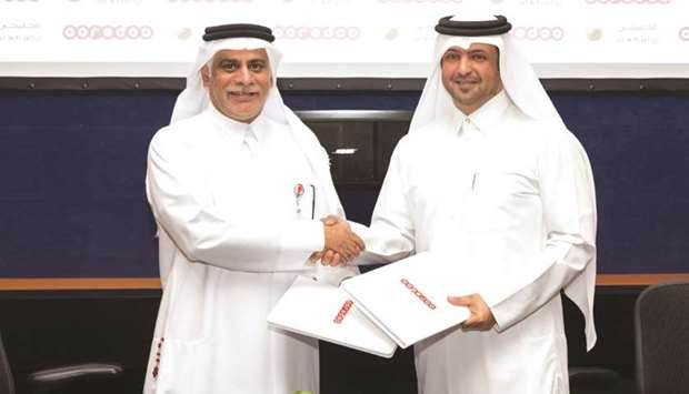 Yousuf al-Kubaisi (left) and Hamad al-Kubaisi at the agreement signing. Ooredoo has signed a partnership with al khaliji to enable its customers pay for Ooredoo services from their al khaliji bank accounts via online banking.