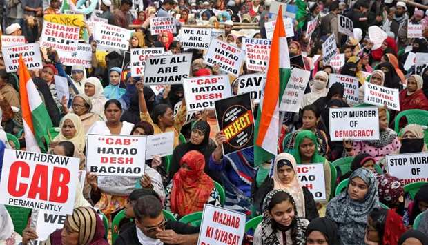 Women display placards during a protest against a new citizenship law, in Kolkata