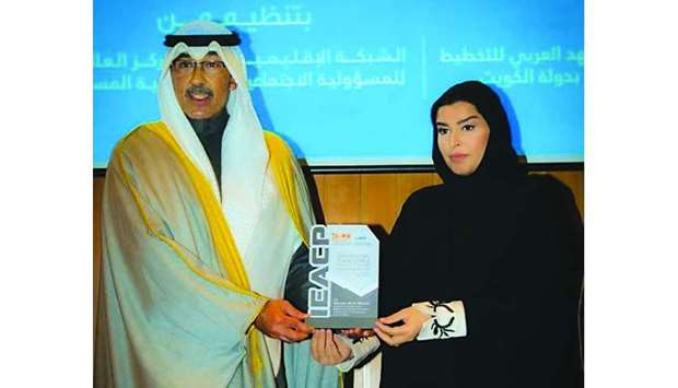 Mariam bint Nasser bin Ali al-Misnad being conferred the title of International Ambassador for Orphans at the forum in Kuwait.
