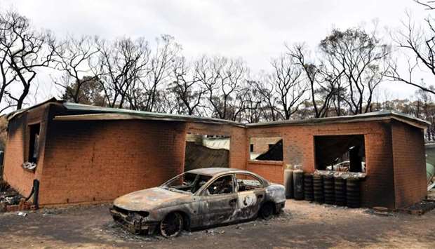 A house and car damaged by Saturday's catastrophic bushfires in the Southern Highlands village of Balmoral, Australia