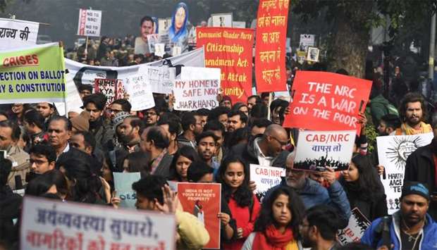 Protesters hold placards at a demonstration against India's new citizenship law in New Delhi