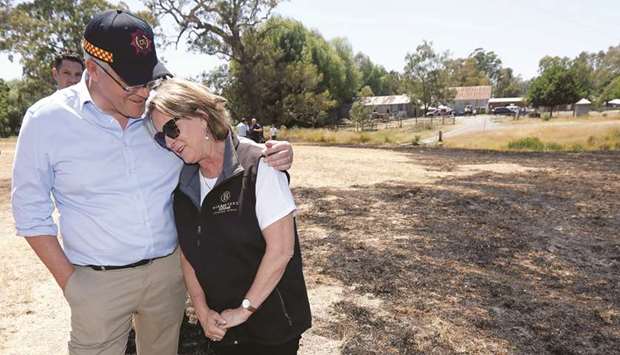 Australian Prime Minister Scott Morrison comforts Jan Sienielink-Allen, the owner of Barristeru2019s Block Winery, in Woodside, Australia, as he tours areas affected by the bushfires.