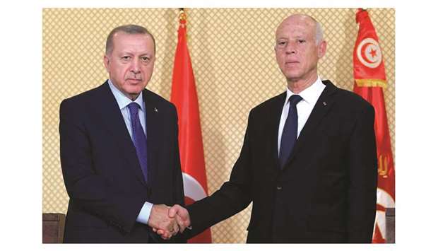 Tunisian President Kais Saied shakes hands with Turkish President Recep Tayyip Erdogan during a joint press conference at the presidential palace in Carthage, east of the capital Tunis, yesterday.