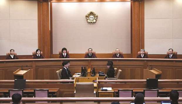 South Koreau2019s Constitutional Court chief judge Yoo Nam-seok and other judges sit for the ruling on controversial u2018comfort womenu2019 deal between South Korea and Japan at the court in Seoul yesterday.