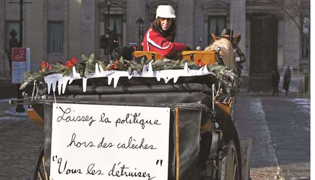 A horse-drawn carriage passes by in a street of Old Montreal, Quebec, Canada.
