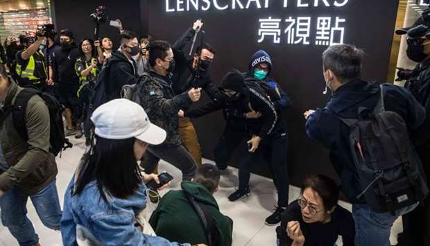 Plainclothes police officers (with batons) clash with a pro-democracy protester during a rally inside a shopping mall in Sheung Shui in Hong Kong. AFP
