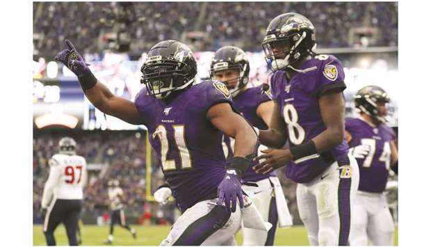 Baltimore Ravens running back Mark Ingram (left) celebrates with quarterback Lamar Jackson (right) after a touchdown against the Houston Texans in Baltimore on November 17, 2019. (Getty Images/TNS)