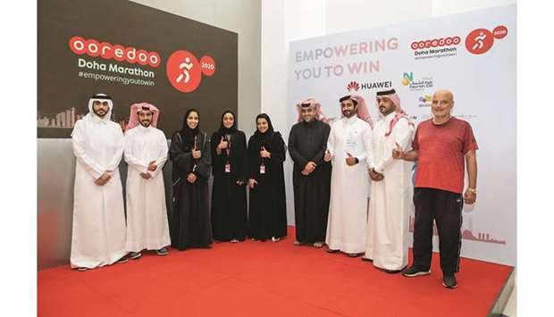 Manar Khalifa al-Muraikhi, Director PR and Corporate Communications at Ooredoo, addressing the media. (Right) Officials pose after the press conference.