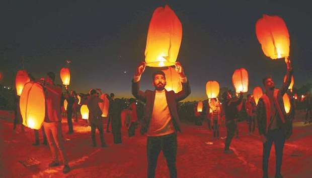 Iraqis in the holy city of Najaf launch rice paper hot air balloons yesterday, to show their solidarity with the ongoing anti-government protests across the country.