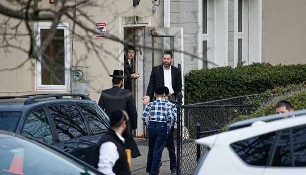 Members of the Jewish community leave from a synagoge next to the home of rabbi, Chaim Rottenbergin Monsey, in New York after a machete attack that took place earlier outside the rabbi's home during the Jewish festival of Hanukkah in Monsey, New Yor