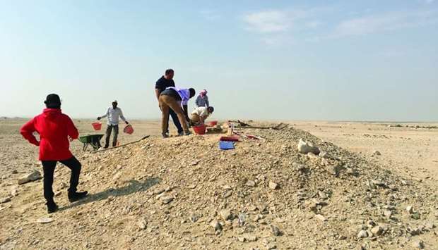 Researchers excavating a pre-Islamic burial mound in the Asaila area west of Umm Bab in order to recover skeletal remains
