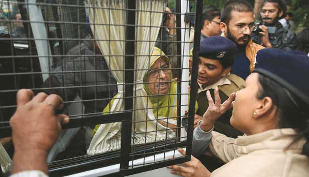 A protester (centre) is detained by police in Ahmedabad yesterday.