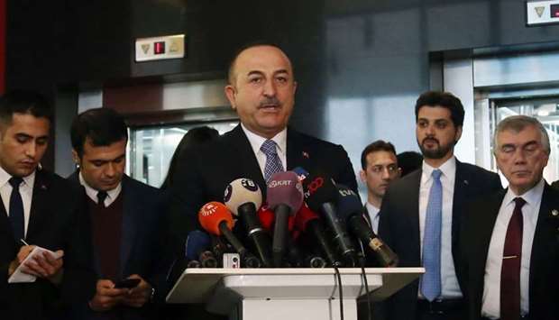 Turkish Foreign Minister Mevlut Cavusoglu (C) holds a press conference after his meeting with Chairman of the Republican People's Party (CHP) at the headquarters of the Republican People's Party (CHP) prior to Turkish parliament session for possible military deployment in Libya, in Ankara