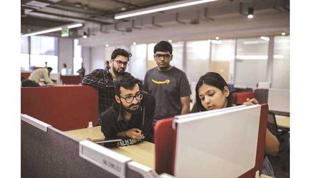 Employees work in an office area at the Amazon India office campus in Hyderabad. The Indian e-commerce market is expected to reach $200bn by 2026 from the current $48.5bn (as of 2018) and to create a level-playing field for small and medium players, the government brought in a new e-commerce policy and fresh rules around FDI in the sector in February this year that forced online marketplaces like Amazon India to change its ownership pattern.