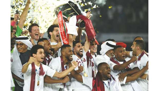 In this February 1, 2019, picture, Qataru2019s players celebrate with the trophy after winning the 2019 AFC Asian Cup final against Japan in Abu Dhabi. (AFP)