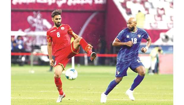 Bahrainu2019s Ali Madan (left) in action with Kuwaitu2019s Amer al-Fadhel during the Arabian Gulf Cup match yesterday. PICTURES: Jayan Orma