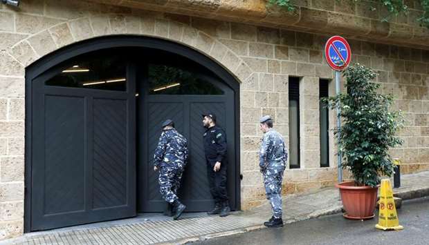 Lebanese police officers are seen at the entrance to the garage of what is believed to be former Nissan boss Carlos Ghosn's house in Beirut, Lebanon