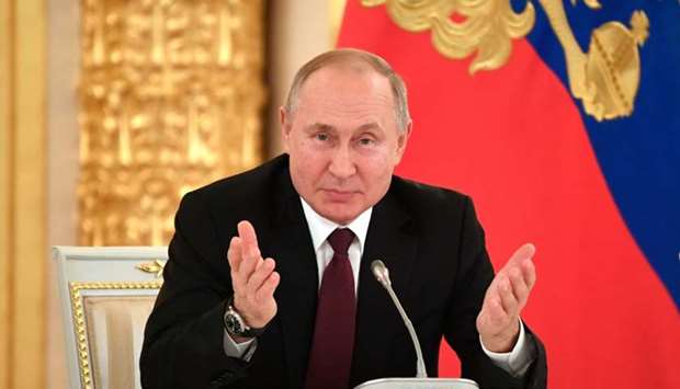 Russian President Vladimir Putin gestures during his meeting with business community at the Kremlin in Moscow, on December 25
