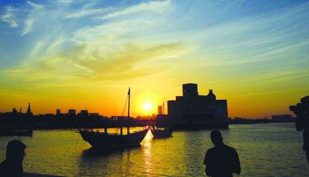 People capturing the last sunset of 2019 Tuesday on Doha Corniche, near the Museum of Islamic Art. PICTURE: Thajudheen