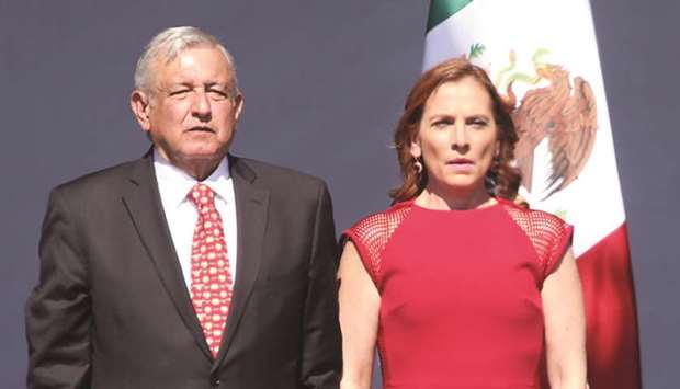 Mexican President Andres Manuel Lopez Obrador, accompanied by his wife, Beatriz Gutierrez Muller, attend the anniversary of his first year in office at the Zocalo Square in Mexico City, Mexico.