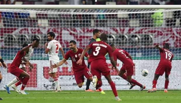 Qatar's Boualem Khoukhi celebrates scoring their fourth goal with teammates