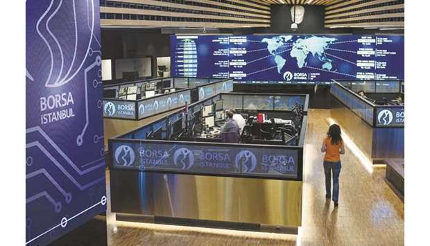 Employees work in their booths at the Borsa Istanbul stock exchange (file). Istanbulu2019s main equity gauge is among the five best-performing benchmarks in the second half of this year, up 12% since the start of July, double its advance in the first six months.