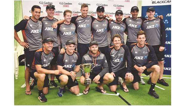 New Zealand players pose with the trophy after winning England series at Seddon Park in Hamilton yesterday. (AFP)